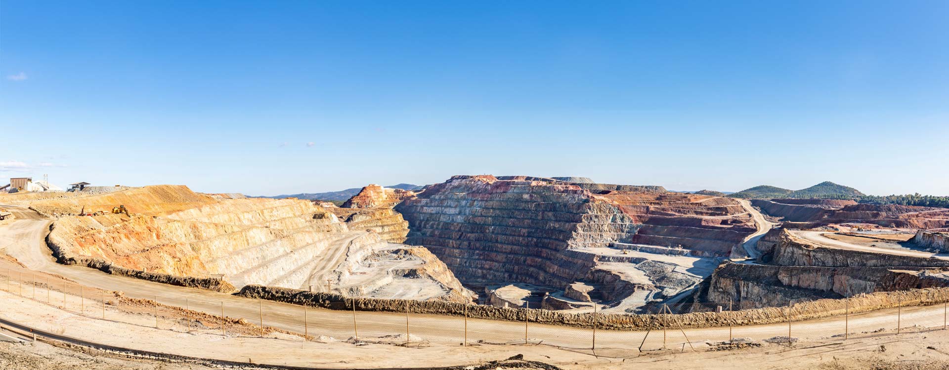 Panorama of Corta Atalaya with mining levels at open mine pit. Deep excavation of pyrite and extraction of minerals of cooper and gold in municipality of Minas de Riotinto, Huelva, Andalusia, Spain